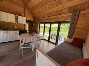 a bedroom with a bed and a table in a room at Chalet en bois indépendant, terrasse et accès piscine in Montret