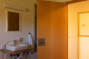 a bathroom with a sink and a mirror at FarNorth Hostel in Bakkafjörður