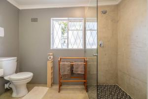 a bathroom with a toilet and a glass shower at 30 on Oatlands Accommodation Makhanda Grahamstown in Grahamstown +70 photos