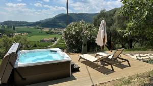 a hot tub with two chairs and an umbrella at Il Parnaso Relais in Longare +32 photos