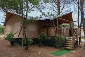 a house with a tent with a staircase and trees at Tente chauffée avec piscine lagon in Vallon-Pont-dʼArc