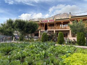 a large building with a garden in front of it at Lavender House in Nubra
