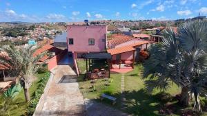 an aerial view of a house with palm trees at Fonsecas House Suíte Privativas in Paraguaçu