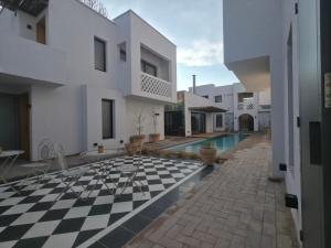 a house with a checkered floor and a swimming pool at Stipa Boutique Hotel in Chacras de Coria