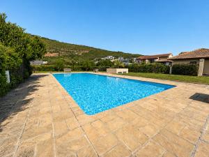 a swimming pool in the backyard of a house at Captains Quarters in Plettenberg Bay