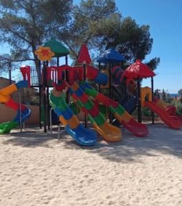 a playground with a slide in the sand at Premium Sea View in Saint-Raphaël