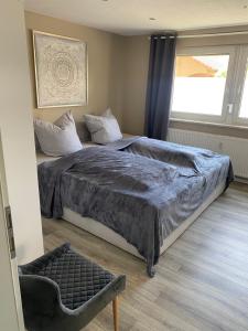 a bedroom with a large bed and a window at Ferienwohnung Weitblick in Rodalben