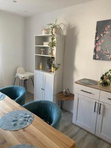 a dining room with a table and blue chairs at Ferienwohnung Weitblick in Rodalben