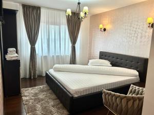 a bedroom with a bed and a large window at Pensiunea Alexia in Novaci-Străini +14 photos