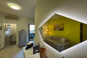 a kitchen and a living room with a couch at El Prestinée Box auto gratuito in Milan
