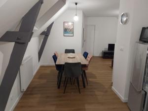 a dining room with a table and chairs at Aux Cormulets in La Baconnière