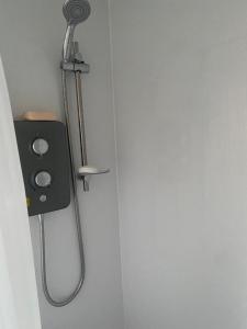 a shower in a bathroom with a shower at Keethz Home in Timperley
