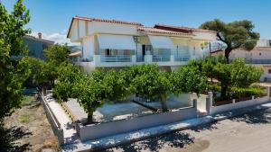a house with trees in front of it at Studios Kerasioti in Pefki