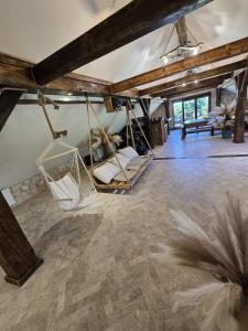 a room with three swings in a building at Apartament-SŁOVIAŃSKI ZAKĄTEK in Nowakowo