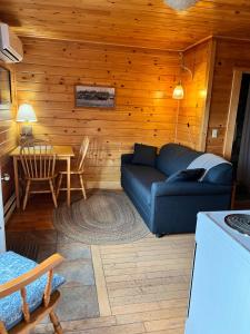 a living room with a couch and a table at Seaside Beach Resort in Saint Andrews