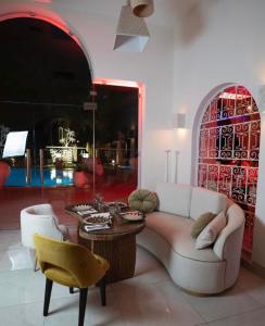 a living room with a couch and a table at Suites Hôtel Les Charmilles & Spa in Tunis