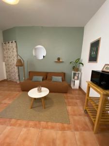 a living room with a couch and a table at APPARTEMENT Malana in Nîmes