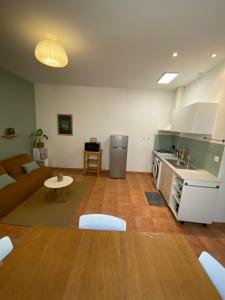 a kitchen and living room with a couch and a table at APPARTEMENT Malana in Nîmes