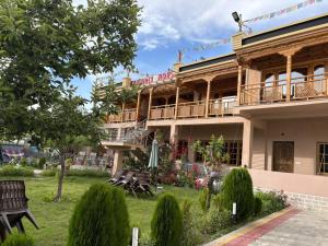 a building with a bunch of benches in front of it at Lavender House in Nubra