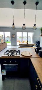 a kitchen with a stove and a counter top at The Kite Cottage in Langebaan +8 photos