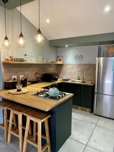 a kitchen with a stove and a refrigerator at The Kite Cottage in Langebaan