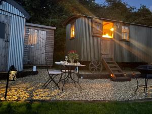 a tiny house with a table in front of it at The Drey in Trelleck +57 photos