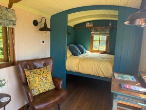 a small room with a bed and a chair at The Drey in Trelleck