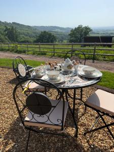 a table with plates of food on it at The Drey in Trelleck