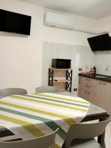 a kitchen with a table and chairs in a room at Antares in Isnello