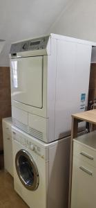 a washer and dryer with a washing machine at Casa Silvia in Promontogno