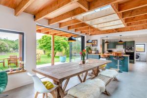 a kitchen and dining room with a wooden table and chairs at 4 Bed in Bugle oc-f34175 in Penwithick