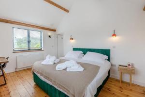 a bedroom with a bed with towels on it at 4 Bed in Bugle oc-f34175 in Penwithick