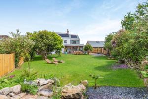 a large yard with a house with a garden at 4 Bed in Bugle oc-f34175 in Penwithick