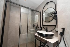 a bathroom with a sink and a shower at Sunset Premium in Keramoti +16 photos