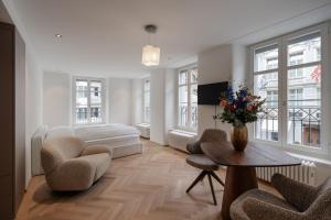 a living room with a couch and a table at ODA Suites - self check-in apartments, old town in Lucerne