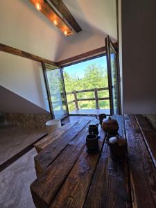 a room with a wooden table with pots on it at Apartament-SŁOVIAŃSKI ZAKĄTEK in Nowakowo +14 photos
