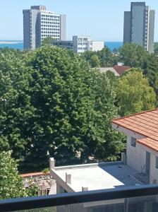 a view from the balcony of a building with trees at Stefan - apartament studio in Saturn