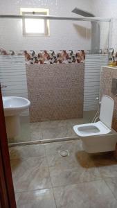 a bathroom with a toilet and a sink at شاليهات الشهد والحلا in Amman