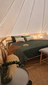 a bedroom with a bed in a tent at B&B Weselo in Mol