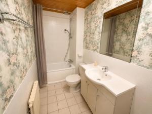a bathroom with a sink and a toilet and a mirror at Aux Roses in Saint-Honoré-les-Bains +20 photos
