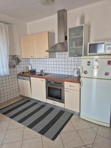 a kitchen with a white refrigerator and a stove at A.M. in Orebić