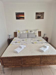 a bedroom with a large bed with two towels on it at A.M. in Orebić