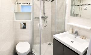 a bathroom with a shower and a toilet and a sink at Beautifully Bright Apartment in Old Town Saint-Tropez in Saint-Tropez +11 photos