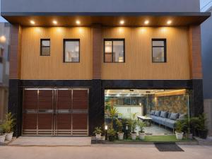 a modern house with a yellow facade at Urben BellaMount Hotel - Free Airport and Aerocity Pick Up & Drop in New Delhi