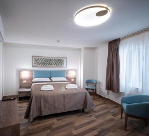 a bedroom with a large bed with a blue headboard at I Segreti del Chiostro - Le Dimore in Palermo