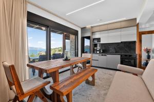 a kitchen and dining room with a wooden table and chairs at September15 Boutique Suites - Nikiana in Nikiana