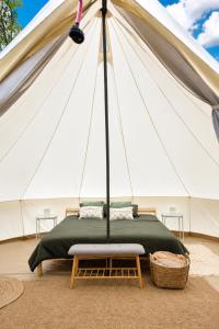 a bed inside of a white tent at B&B Weselo in Mol