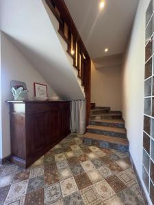 a staircase in a house with a stair case at Casale Rûsignul in Cassegliano +1 photo