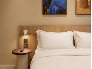 a bedroom with a bed and a nightstand next to a bed at Numa Brighton Pavilion in Brighton & Hove