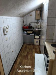 a small kitchen with a kitchen experiment sign on the wall at 10Forward apt2 in Bitola